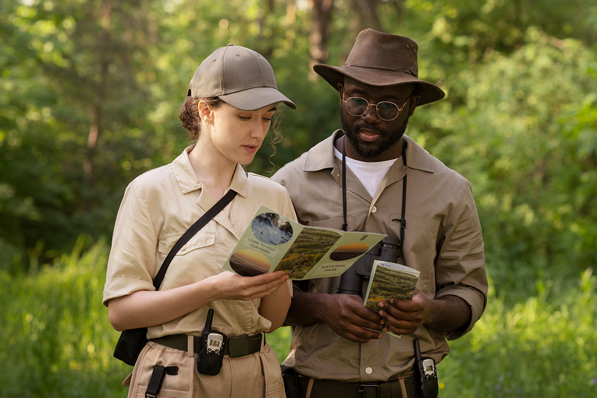 medium-shot-forest-wardens-with-brochure
